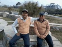 two men are posing for a picture with one wearing a hat that says eagles