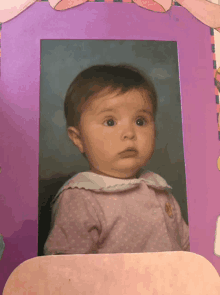 a picture of a baby in a pink polka dot dress