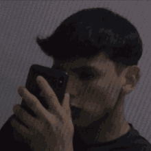 a young man is taking a selfie with his iphone