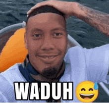 a man in a boat with the word waduh written on his head