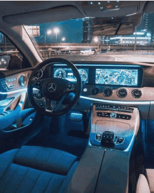 the interior of a mercedes with a steering wheel and dashboard