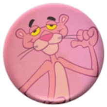 a pink panther with yellow eyes is on a round button