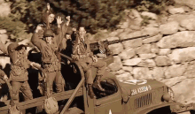 a group of soldiers are riding in the back of a truck with the number 25a a33554-5 on the side