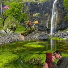 a man and woman are kissing in front of a waterfall