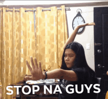 a girl is making a stop na guys sign with her hands