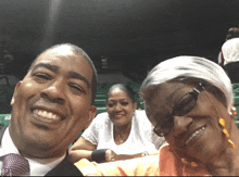 a man and two women are posing for a picture