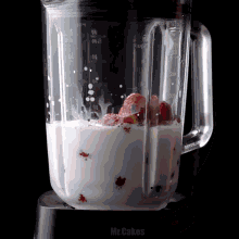 a blender filled with strawberries and milk has the word mr.cakes on the bottom