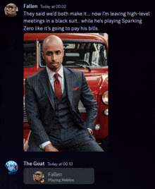 a man in a suit and tie is sitting on the back of a red car