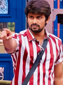 a man with a beard wearing a red and white striped shirt