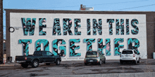 a mural on the side of a building that says " we are in this together "