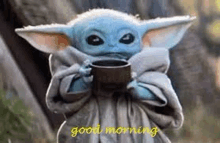 a baby yoda from star wars is holding a cup of coffee and saying good morning .