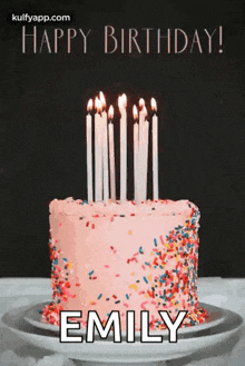 a birthday cake with candles and sprinkles and the name emily on it