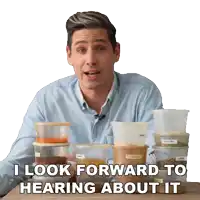 a man sitting at a table with containers of food and the words " i look forward to hearing about it "