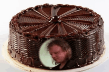 a large chocolate cake with a picture of a man in the middle .