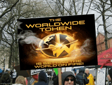 a sign that says ' the worldwide token is setting the world on fire ' on it