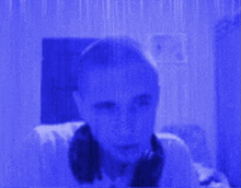 a man 's face is visible through a blue screen .