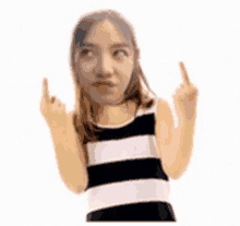 a woman in a striped tank top is making a funny face and giving the middle finger .