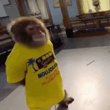 a monkey is wearing a yellow shirt that says moujou on it