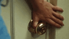 a close up of a person 's hand holding a door handle .