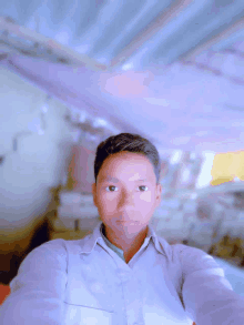 a young man taking a selfie in front of a purple background