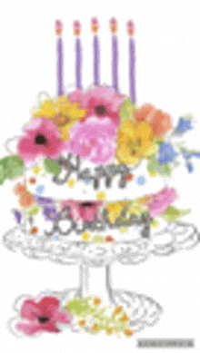 a birthday cake with flowers and candles on a cake stand