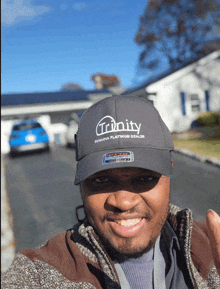 a man wearing a trinity platinum dealer hat