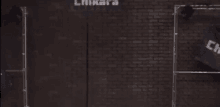 an aerial view of a brick wall with a sign that says ' lnkara ' on it .