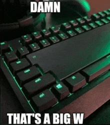 a close up of a computer keyboard with the words `` damn that 's a big w '' written on it .