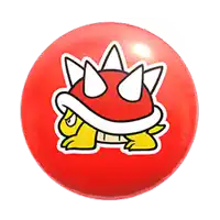 a red ball with a sticker of a cartoon turtle on it