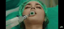 a woman in an operating room with an oxygen mask on her face