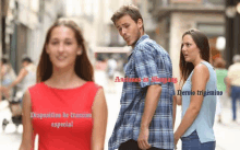 a man in a plaid shirt is looking at a woman in a red dress on a city street .