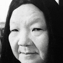 a close up of a woman 's face in a black and white photo with long hair .