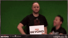 a man holds a sign that says d & d beyond