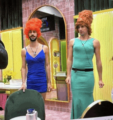 a man in a blue dress stands next to another man in a green dress in front of a sign that says bermond