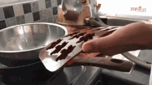 a person is using a spatula to remove chocolate from a mould on a stove top with the words zaracute in the background