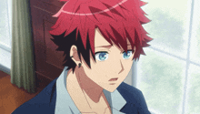 a boy with red hair and blue eyes looks at something