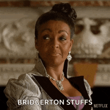 a woman is wearing a silver jacket and a necklace and says bridgerton stuffs netflix