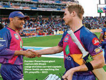 two cricket players shaking hands on a field with a crowd in the background