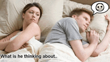 a man and a woman are laying in bed and the man is thinking about something