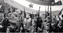 a black and white photo of soldiers holding guns and a flag with a red star on it