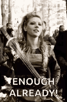 a black and white photo of a woman holding a sword with the words `` enough already '' written on it .