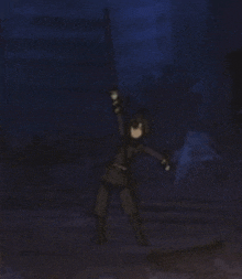 a person is standing in the dark holding a sword in their hand .