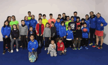 a group of kids posing for a picture with one wearing a jacket that says camper