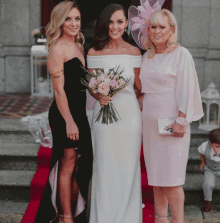 a bride and her mother pose for a photo