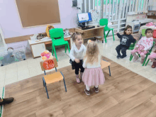 a group of children are playing in a room with a sign on a chair that says " happy birthday "