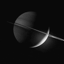 a black and white photo of saturn with its rings