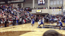 a basketball game is being played in front of a crowd with a scoreboard that shows the score of 41 to 17