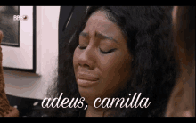 a woman is crying with the words " adeus camilla " written below her