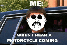 a man wearing sunglasses and a mustache is sitting in a car .