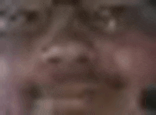 a blurry picture of a man 's face with a blurred background .